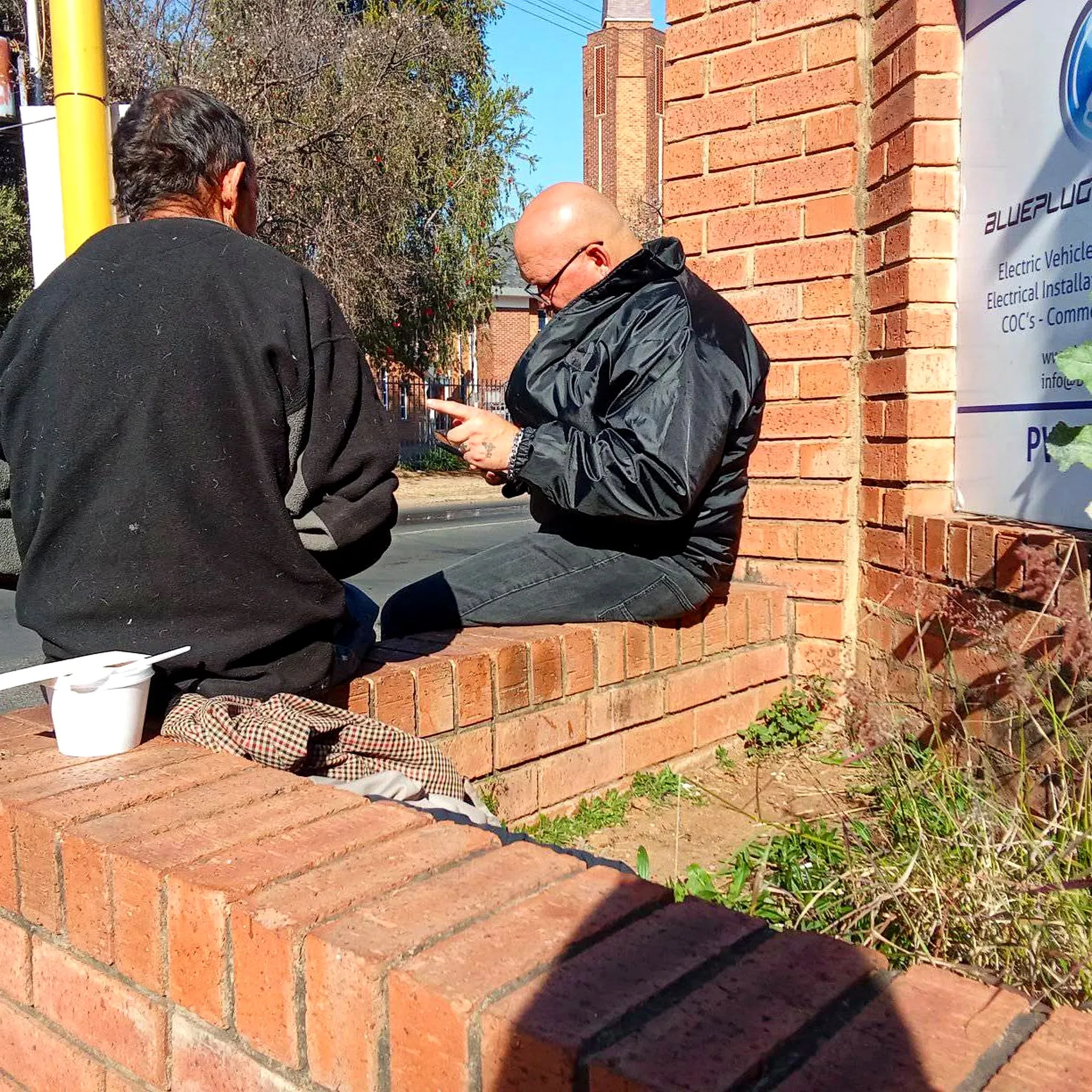 Two men sharing a conversation during Tuesday street outreach
